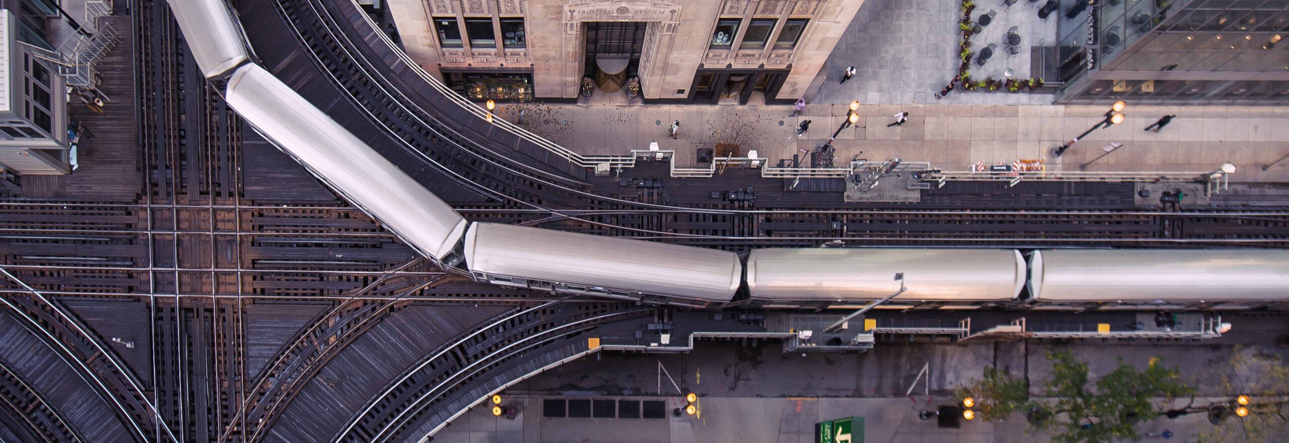 Aerial view of a Chicago L train turning around a building